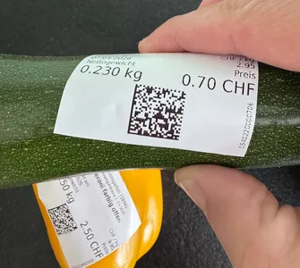 Data Matrix codes printed on labels, located on fresh produce with curved surfaces